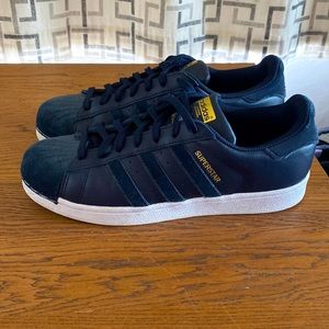 Unique woman’s superstar adidas shell toe sneaker.